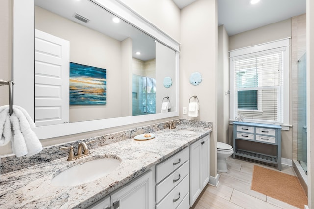 bathroom with vanity, a shower with shower door, wood-type flooring, and toilet