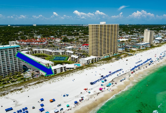 birds eye view of property featuring a water view and a beach view