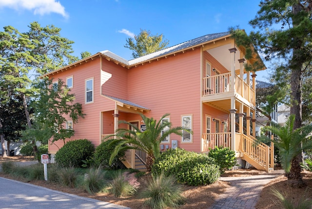 view of front of property featuring covered porch and a balcony