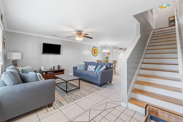 living room with crown molding, light tile patterned floors, and ceiling fan with notable chandelier