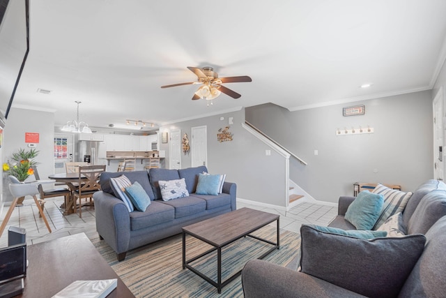 tiled living room with ornamental molding and ceiling fan with notable chandelier