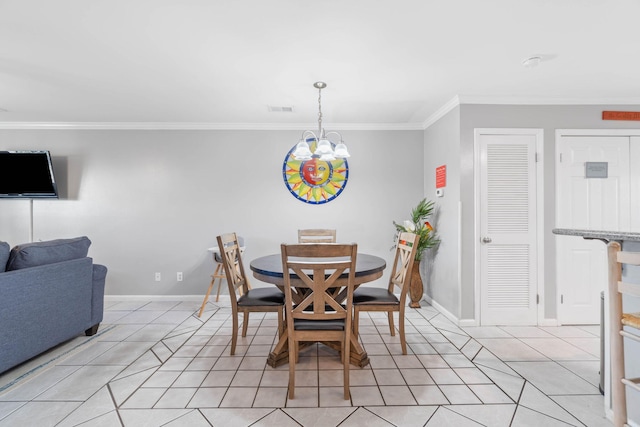 dining area with crown molding, an inviting chandelier, and light tile patterned floors