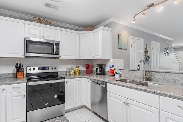 kitchen with ornamental molding, sink, white cabinetry, and stainless steel appliances