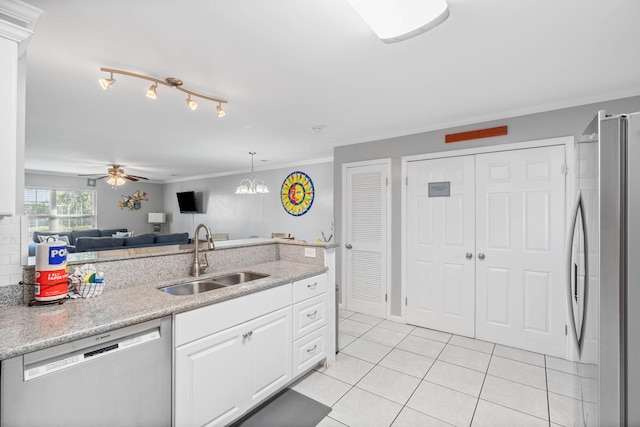 kitchen featuring appliances with stainless steel finishes, sink, white cabinets, ornamental molding, and light tile patterned floors