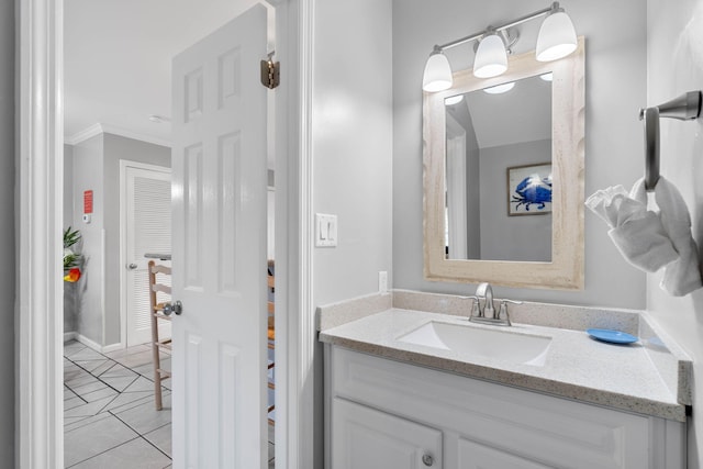 bathroom with vanity, ornamental molding, and tile patterned flooring