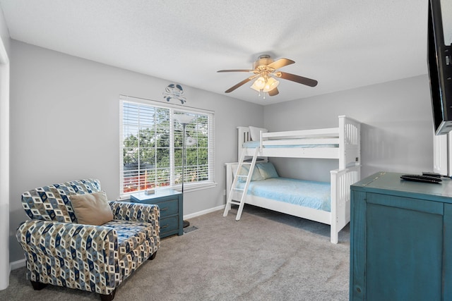 bedroom with ceiling fan, light carpet, and a textured ceiling