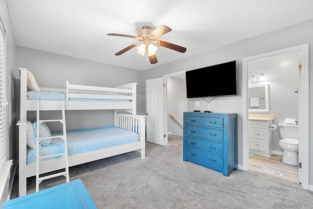 carpeted bedroom featuring connected bathroom and ceiling fan