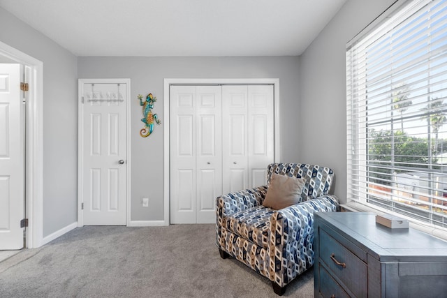 living area featuring light carpet