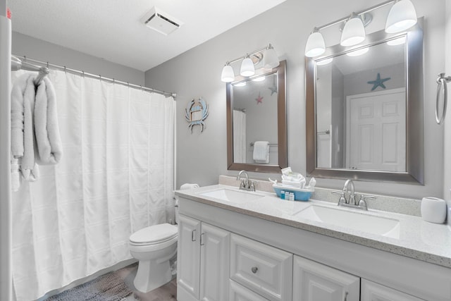 bathroom featuring vanity, wood-type flooring, toilet, and walk in shower