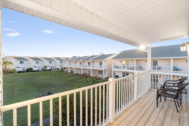 wooden deck with a lawn