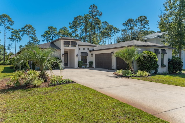 view of front of home featuring a front lawn and a garage