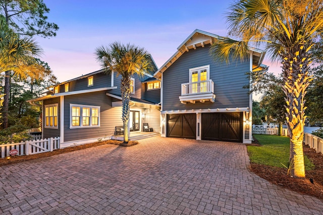 view of front of property with a garage and a balcony