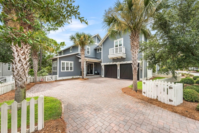 view of front of property with a garage and a balcony