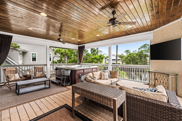 wooden terrace featuring ceiling fan, a hot tub, and an outdoor living space