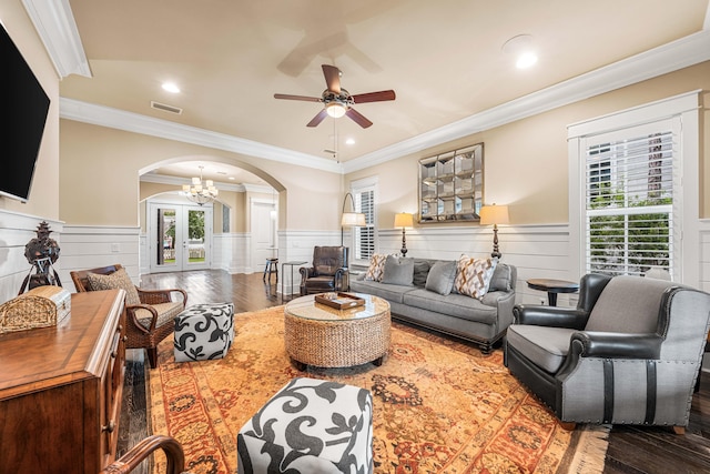 living room featuring crown molding, hardwood / wood-style flooring, and a wealth of natural light