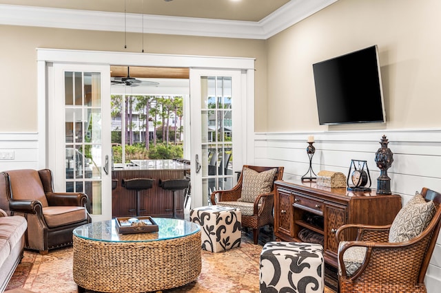 living room featuring crown molding and ceiling fan