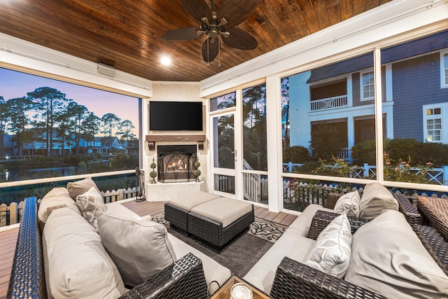 sunroom with wood ceiling and ceiling fan