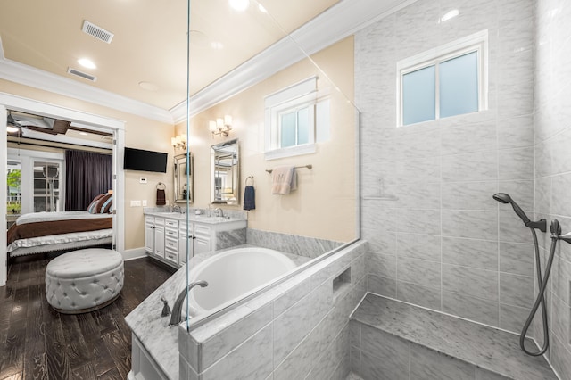 bathroom featuring vanity, ornamental molding, plenty of natural light, and hardwood / wood-style floors