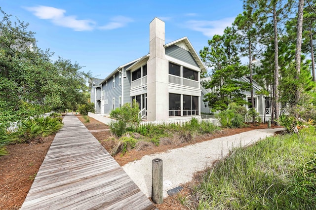 rear view of property featuring a sunroom