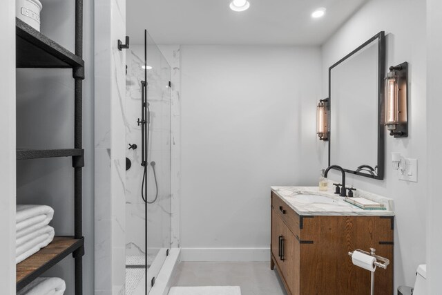bathroom featuring toilet, vanity, and tiled shower