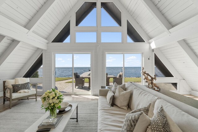 living room featuring high vaulted ceiling, a water view, and beamed ceiling