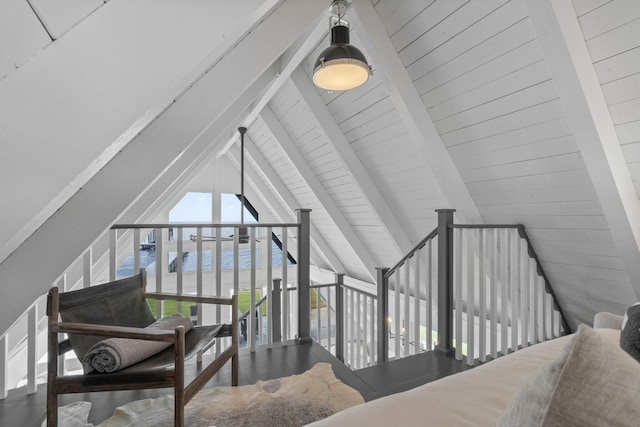 interior space featuring lofted ceiling with beams and a water view