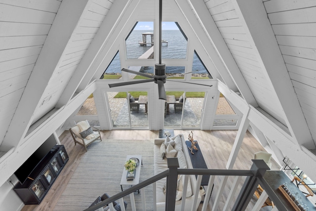 living room with plenty of natural light, a water view, hardwood / wood-style flooring, and wooden ceiling