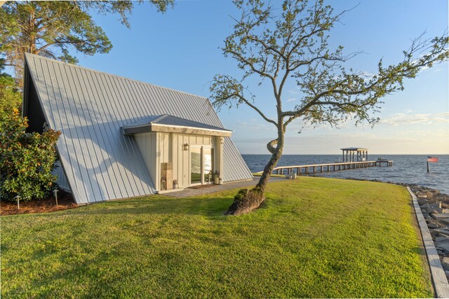 exterior space with a dock and a water view