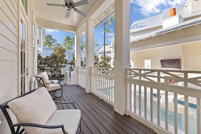 sunroom / solarium featuring ceiling fan