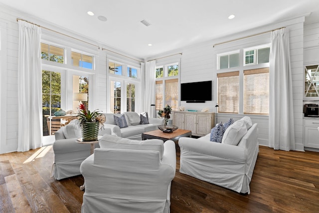 living room featuring crown molding and dark wood-type flooring