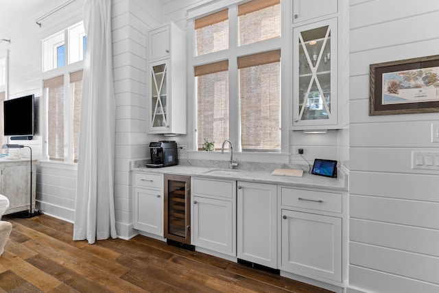 kitchen with wine cooler, dark hardwood / wood-style floors, sink, and a wealth of natural light