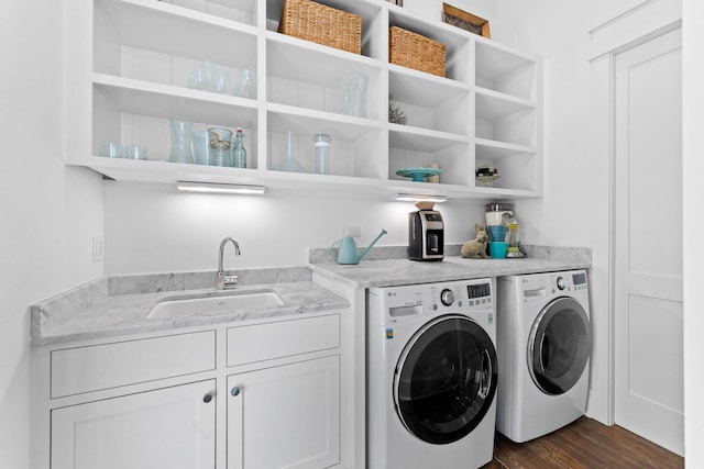 laundry room featuring cabinets, dark hardwood / wood-style flooring, separate washer and dryer, and sink