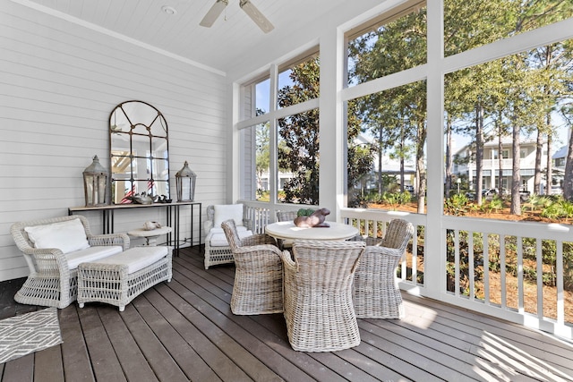 sunroom featuring ceiling fan