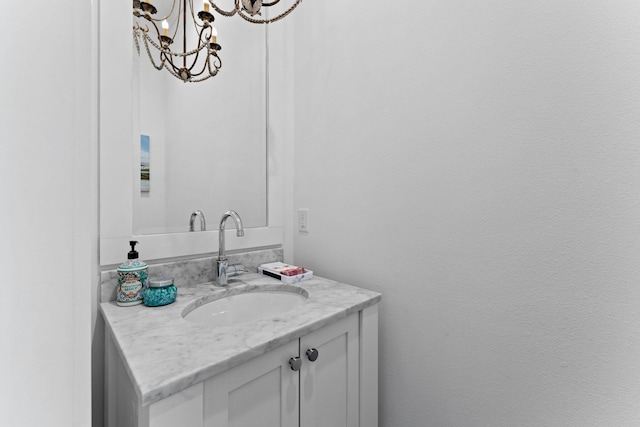 bathroom featuring a notable chandelier and vanity