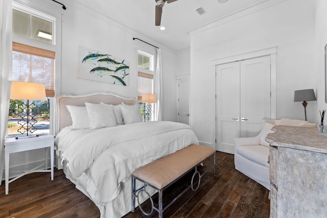 bedroom with a closet, ceiling fan, dark hardwood / wood-style flooring, and crown molding