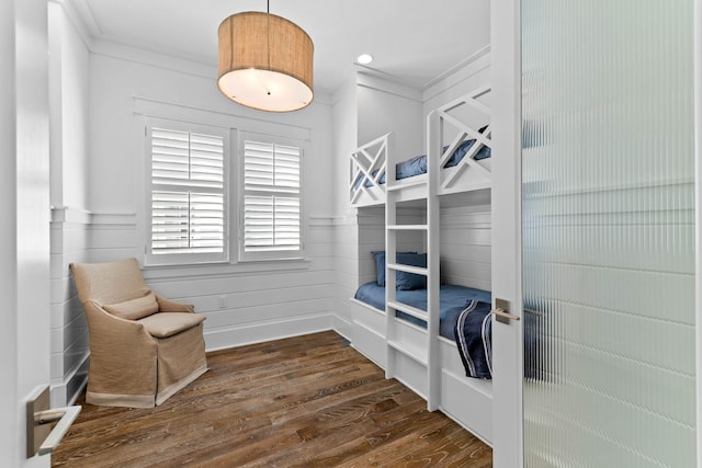 bedroom with dark hardwood / wood-style flooring and ornamental molding