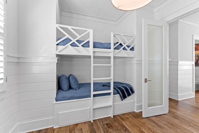 bedroom with wood-type flooring and ornamental molding