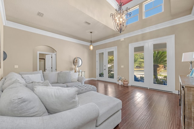 living room featuring french doors, ornamental molding, and dark wood-type flooring