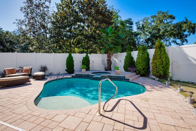 view of swimming pool with an in ground hot tub and a patio area