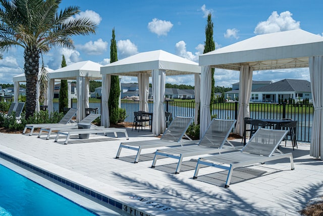 exterior space featuring a water view, a gazebo, and a community pool