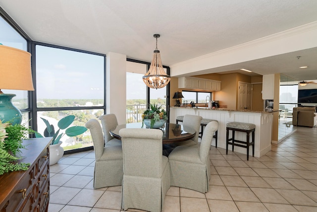 tiled dining area featuring a wall of windows and plenty of natural light