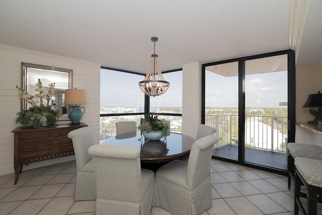 dining area with an inviting chandelier, a healthy amount of sunlight, and light tile patterned floors