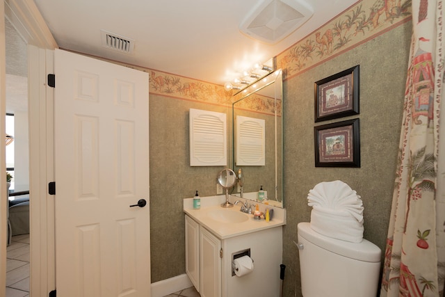 bathroom with vanity, toilet, and tile patterned floors