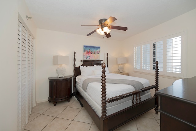 tiled bedroom featuring ceiling fan