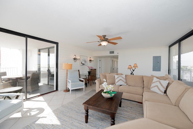 tiled living room featuring electric panel, floor to ceiling windows, and ceiling fan