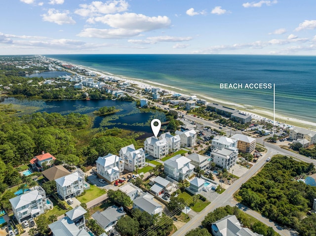 birds eye view of property with a water view and a view of the beach