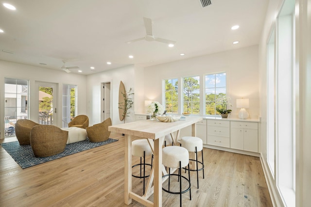 kitchen featuring white cabinetry, light wood-type flooring, and ceiling fan