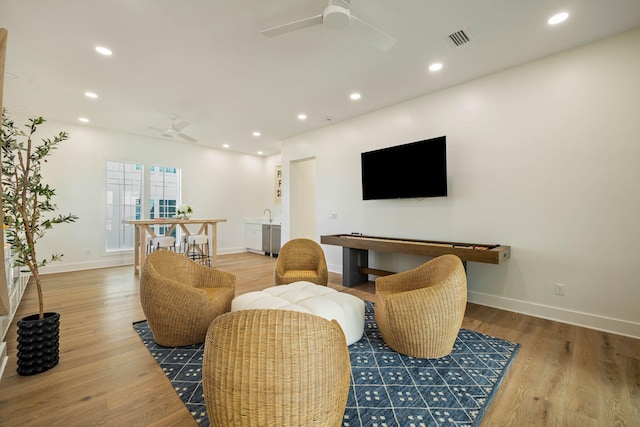 living room with hardwood / wood-style floors and ceiling fan