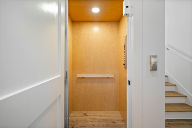 details with wood-type flooring and elevator