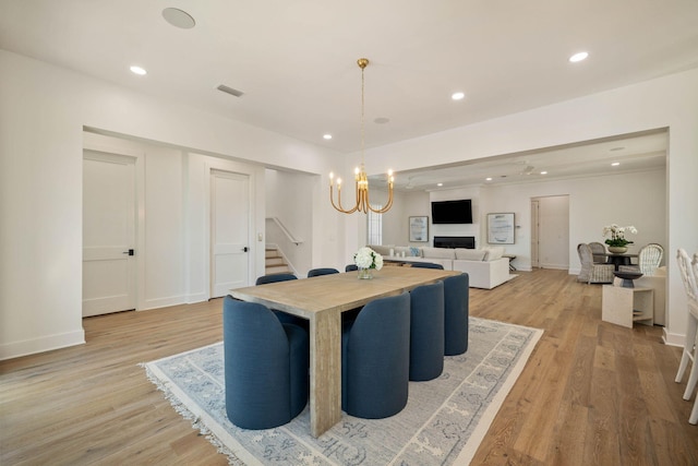 dining room with a notable chandelier and light wood-type flooring